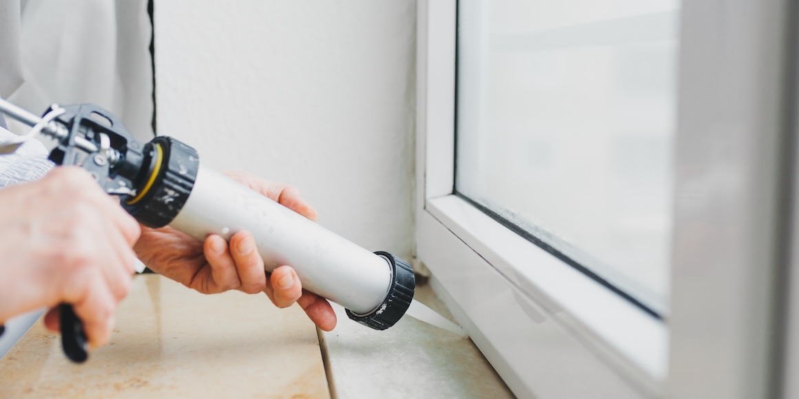 Contractor using a caulk gun on a home project