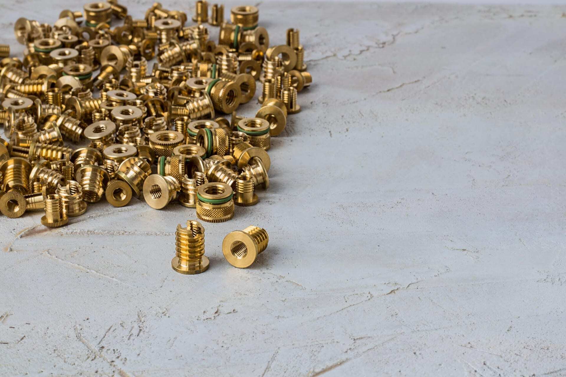 Lots of Threaded Inserts for Plastic on a Table